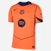 Nike Barcelona Third Kit 25/26 in bright orange with short sleeves and V-neck collar, front view.