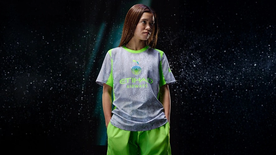 Manchester City Third Kit 25/26 in silver-grey with neon green details and raindrop pattern.