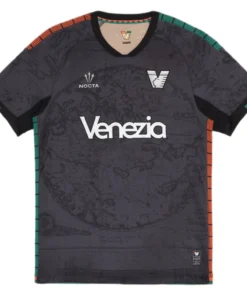 NOCTA Venezia Home Kit 25/26 in black with bold orange and green details, V-neck, short sleeves, front view.