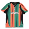 NOCTA Venezia Third Kit 25/26, orange and green stripes, V-neck collar, short sleeves, front view.