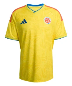 Adidas Colombia Home Jersey 2026, front view, yellow with butterfly-wing-inspired motifs, V-neck collar, short sleeves.