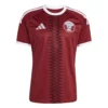 Adidas Qatar Home Kit 2026, front view, maroon base with white details, crewneck, short sleeves.