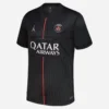 Jordan PSG Fourth Kit 25/26, black with red stripe, grey and pink accents, short sleeves, front view.