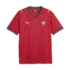 Front view of Portugal Home Kit 2026 by PUMA, striking red base with green accents, v-neck, short sleeves.