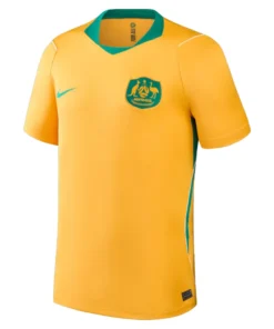 Australia Home Kit 2026 by Nike, front view in golden yellow with green accents, V-neck and short sleeves.