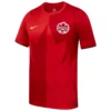 Nike Canada Home Jersey 2026, front view with bold red design, maple leaf graphic, short sleeves.