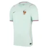 France Away Kit 2026 by Nike, front view in soft green with tricolour sleeve details, crewneck, and short sleeves.