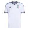 Front view of Italy Away Kit 2026. Light blue jersey with tailored weave pattern, gold accents, and a crossover v-neck collar.