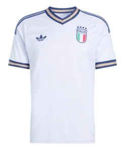 Front view of Italy Away Kit 2026. Light blue jersey with tailored weave pattern, gold accents, and a crossover v-neck collar.