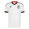 Front view of Mexico Away Jersey 2026. White kit with grey ancient-style pattern, green and red trim, and V-neck collar.