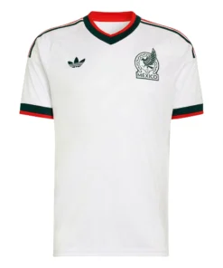 Front view of Mexico Away Jersey 2026. White kit with grey ancient-style pattern, green and red trim, and V-neck collar.