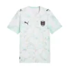 PUMA Austria Away Kit 2026, front, white marble design, turquoise and magenta accents.