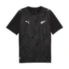 Front view New Zealand Home Kit 2026 by PUMA. Black base, silver fern pattern, short sleeves.