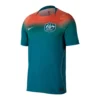 Nike Australia Away Kit 2026, front view, bold coral and dark green transition with a crew neck and white accents.