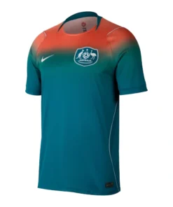 Nike Australia Away Kit 2026, front view, bold coral and dark green transition with a crew neck and white accents.