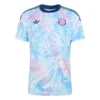 Costa Rica Away Jersey 2026 by adidas, front view. Features pale teal, light violet, off-white tropical pattern and pink crest.