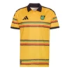 Front view of the adidas Jamaica Home Jersey 2026 in Bold Gold, featuring vivid reggae stripes and a black polo collar.