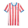 Front view of Paraguay Home Jersey 2026 by PUMA. White base, red stippled stripes, crewneck, short sleeves.