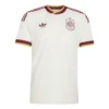 Adidas Spain Away Kit 2026, front view, off-white with manuscript pattern, gold and burgundy cuffs, short sleeves.