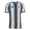 Front view of the Newcastle United Home Kit 26/27 featuring black-and-white stripes with blue collar and sleeve accents.
